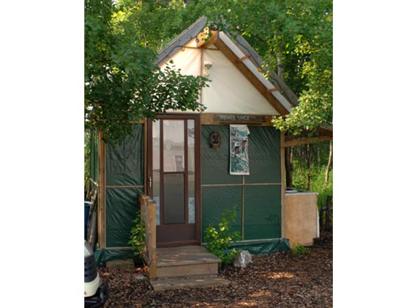 A green shack which states Shower Shack on a sign.